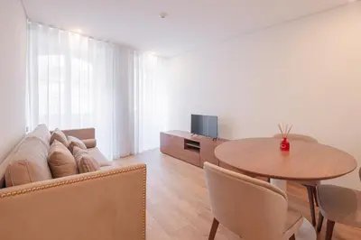 a living room with a table and a couch at Alliança Suites 1909 - Porto in Porto