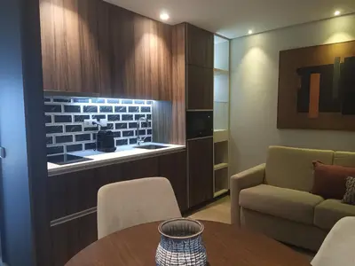 a living room with a table and chairs and a couch at BrandApartments in Porto