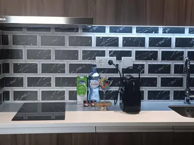 a kitchen counter with a sink and a bottle of cleaner at BrandApartments in Porto