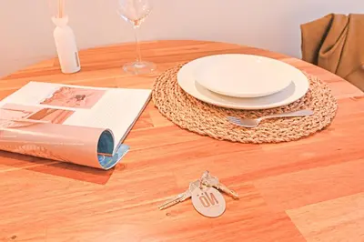 a white bedroom with a bed and a table at FindMe InPorto Bonfim in Porto