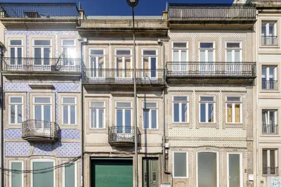a facade of a building with windows and balconies at Design Poveiros Duplex in Porto