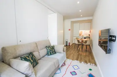a living room with a couch and a table at Heroísmo Cosy Loft in Porto