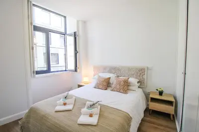 a bedroom with a bed with two towels on it at Heroísmo Cosy Loft in Porto