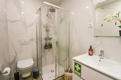a bathroom with a shower and a sink and a toilet at Heroísmo Cosy Loft in Porto