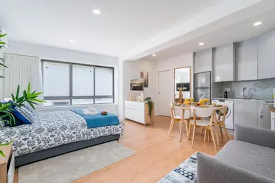 a bedroom with a bed and a kitchen with a table at Host Wise - Comfy Sunny Flat - Prime Location in Porto