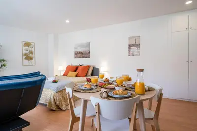 a dining room with a table with food on it at Host Wise - Comfy Sunny Flat - Prime Location in Porto