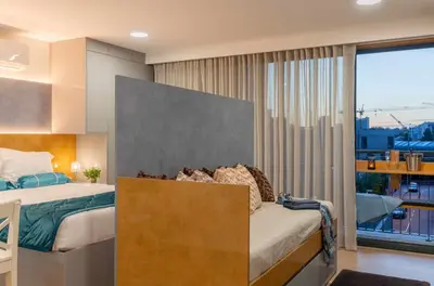 a bedroom with a bed and a large window at 24 Porto Novíssímo Estudio em Cedofeita AC Olive in Porto