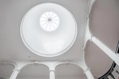 a white room with a round window in the ceiling at GuestReady - Beer Garden in Porto