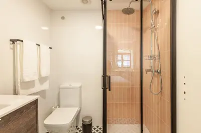 a bathroom with a toilet and a glass shower at Dasi House in Porto