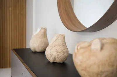 three vases sitting on a table in front of a mirror at GuestReady - Casa da Música Cosmopolitan Comfort in Porto