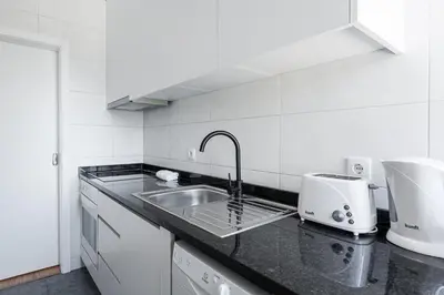 a kitchen with a sink and a mixer on a counter at GuestReady - Casa da Música Cosmopolitan Comfort in Porto