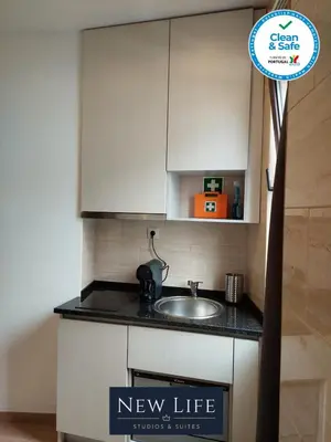 a kitchen with a new life sign next to a sink at New Life - TORRE CLÉRIGOS STUDIO-3T in Porto