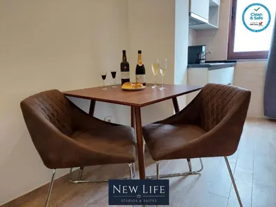a table with two wine glasses and wine bottles at New Life - TORRE CLÉRIGOS STUDIO-3T in Porto