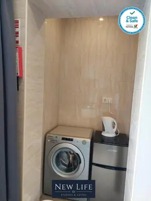 a new life laundry room with a washer and dryer at New Life - TORRE CLÉRIGOS STUDIO-3T in Porto