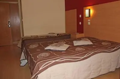 a bedroom with a bed with two pillows on it at Guest House Estrela in Porto