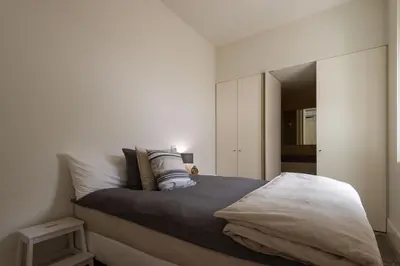 a bedroom with a bed with a large mirror at Porto Grandeur Collection - D. João IV Pool & Garden Apartment in Porto