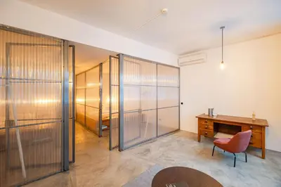 a room with a desk and a chair and a wooden table at Babel in Porto
