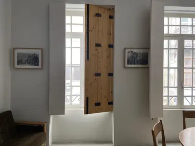 a room with two windows and a wooden door at Babel in Porto