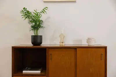 a wooden cabinet with a potted plant on it at Babel in Porto