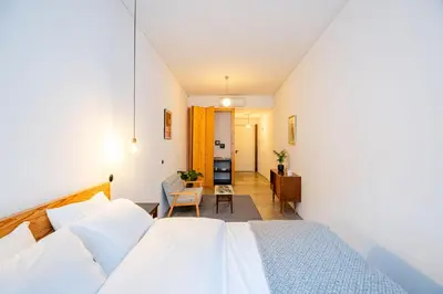 a bedroom with a bed and a dining room at Babel in Porto