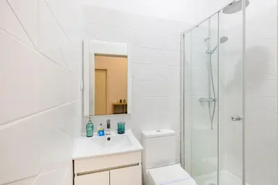 a white bathroom with a toilet and a shower at Balcony City Views in Porto