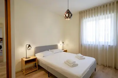 a bedroom with a large white bed and a window at Antero sweet & cozy apartment by PCH in Porto