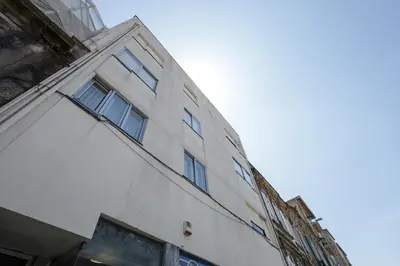 a white building with windows on the side of it at Antero sweet & cozy apartment by PCH in Porto