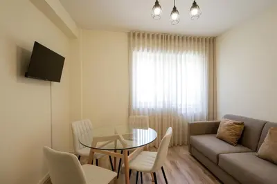 a living room with a glass table and a couch at Antero sweet & cozy apartment by PCH in Porto