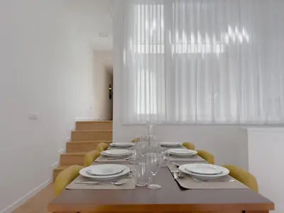 a dining room table with plates and wine glasses at Vibrant Host-Campo 24 Agosto in Porto
