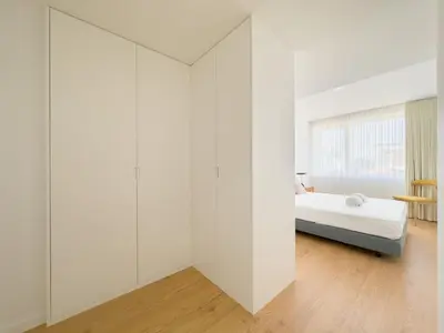 a white room with a bed and a window at Vibrant Host-Campo 24 Agosto in Porto