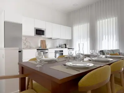 a kitchen with a table with wine glasses on it at Vibrant Host-Campo 24 Agosto in Porto