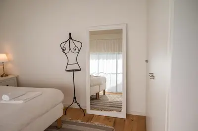 a room with a mirror and a bed and a dresser at Loft in Porto in Porto