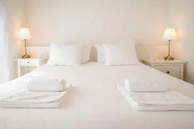 a white bed with two white towels on it at Loft in Porto in Porto