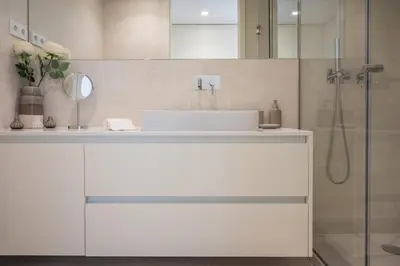 a bathroom with a white sink and a shower at Loft in Porto in Porto