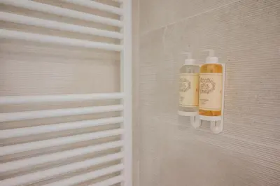 two bottles of shampoo are on a wall at Loft in Porto in Porto