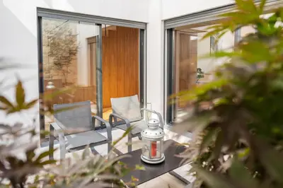a patio with two chairs and a table on a balcony at Loft in Porto in Porto