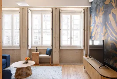 a living room with a tv and a couch at Sao Domingos Stylish Apartment in Porto