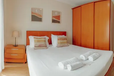 a bedroom with a large white bed with two pillows at Bright Apartment by Hosty in Porto