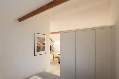 a bedroom with a white cabinet and a dining room at HM - Home Feeling Studio Campanhã in Porto
