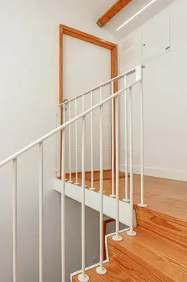 a staircase with white railings in a house at HM - Home Feeling Studio Campanhã in Porto