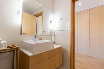 a bathroom with a white sink and a refrigerator at S1405 - practical and modern - AC, balcony and parking in Porto