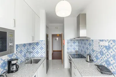 a kitchen with blue and white tiles on the wall at Lolla's City House 2 in Porto