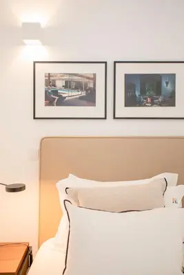 a bedroom with three pictures above a bed at Liiiving in Gaia - Cooper Residence Apartment II in Vila Nova de Gaia