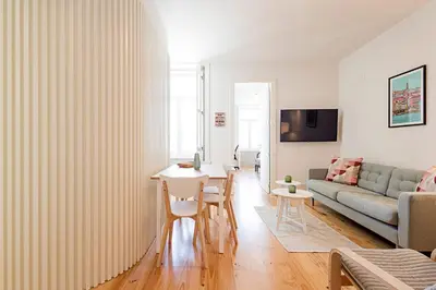 a living room with a couch and a table at Cozy and Homely Getaway by LovelyStay in Porto