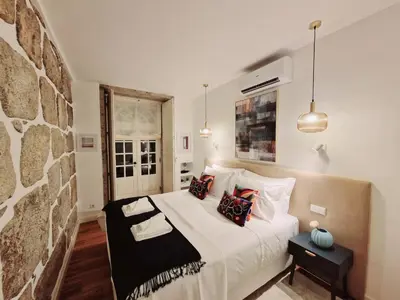 a bedroom with a large bed with pillows on it at OPO Vale Formoso III Balcony&BBQ in Porto