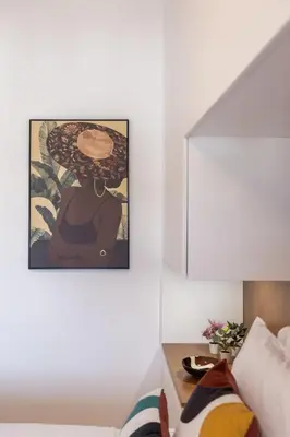 a bedroom with a painting of a woman with an umbrella at OPO Vale Formoso III Balcony&BBQ in Porto