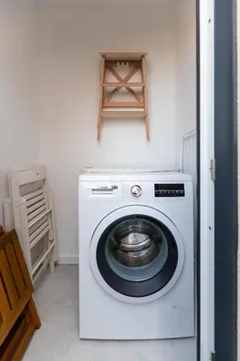 a white washing machine in a room with a shelf at OPO Vale Formoso III Balcony&BBQ in Porto