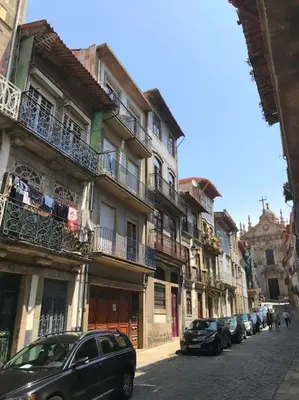 a street with cars parked in front of buildings at The Flat in Porto