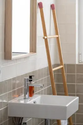 a bathroom with a sink and two wooden supports at The Flat in Porto