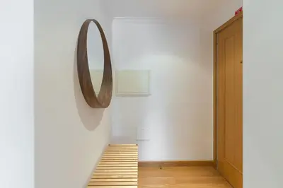 a hallway with a mirror on the wall and a staircase at Host Wise - Deluxe Modern Flat w Balcony in Porto